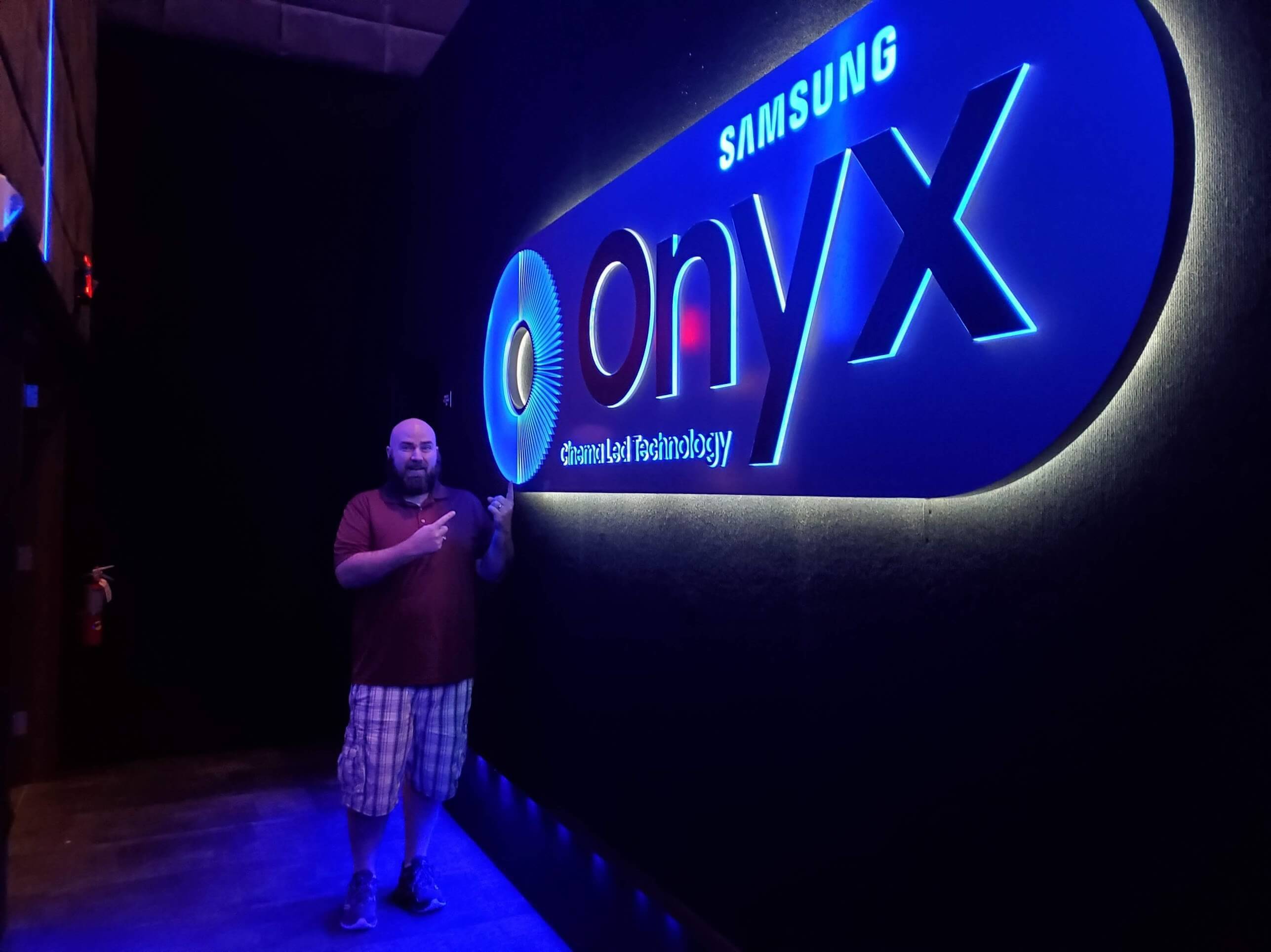brad schaider pointing at onyx sign
